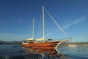 Exterior view of the 33-meter luxury charter gulet Dear Lila anchored in a peaceful bay in Göcek.