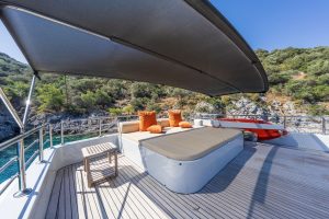 Spacious sun deck and modern outdoor lounge area on Simay F