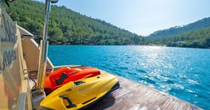 Service boat, snorkeling, and water sports equipment ready for charter guests on Selenge