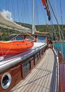 Paddleboards, canoes, and water sports equipment ready for charter guests on Karyalı