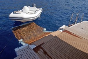 Hydraulic swimming platform, tender, and water sports equipment ready for charter guests on REM