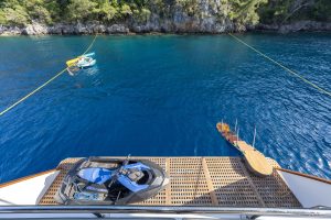 Guests enjoying paddle boards and water sports with the Nayk 3 luxury yacht