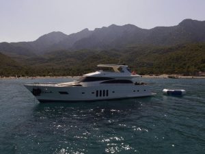 Luxury motor yacht Amolia cruising gracefully in the crystal-clear turquoise waters of Turkey.
