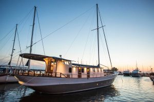 Traditional luxury gulet Cosmos cruising gracefully in the crystal-clear turquoise waters of Turkey.