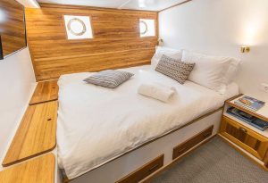 Elegant and comfortable wooden interior cabin accommodation for guests aboard gulet Cosmos.