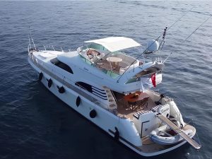 Luxury motor yacht Sirocco cruising in the clear turquoise waters of Fethiye, Turkey.
