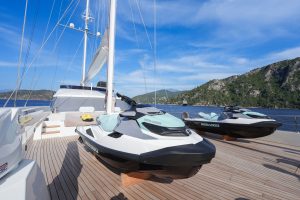 Premium selection of onboard water toys, jet ski, kayaking, and motorized watersports activities on a luxury yacht charter.