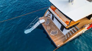 Spacious flybridge and sunbathing deck area of private charter motor yacht Jr Simay