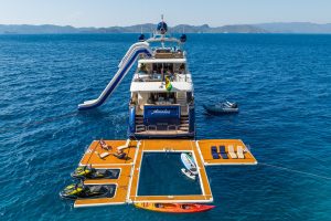 Guests enjoying Sea-Doo jet skis and inflatable platform on Amadea yacht