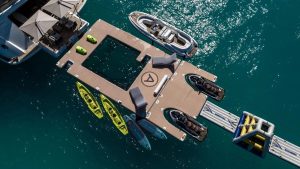Custom inflatable sea pool and water park setup attached to the stern of yacht Artisan.