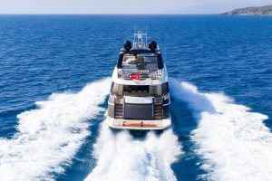 Exterior view of the 26.3-meter Bella Luna luxury motor yacht cruising through the crystal-clear waters of Gocek.