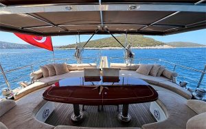 Comfortable sunbathing cushions and shaded seating area on the wide foredeck of Little Gulmaria luxury gulet