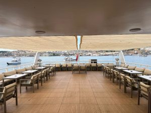 Modern indoor salon and elegant wooden interior design of the luxury event yacht Ruya CZ in Istanbul.