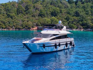 The exterior overview of the twenty-two point five meter Gökçe Motor Yacht cruising gracefully through the blue waters of Göcek bays.