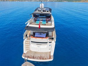 The exterior overview of the twenty-two point five meter Gökçe Motor Yacht cruising gracefully through the blue waters of Göcek bays.